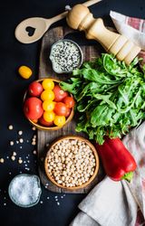 Organic food concept of salad ingredients on bread board