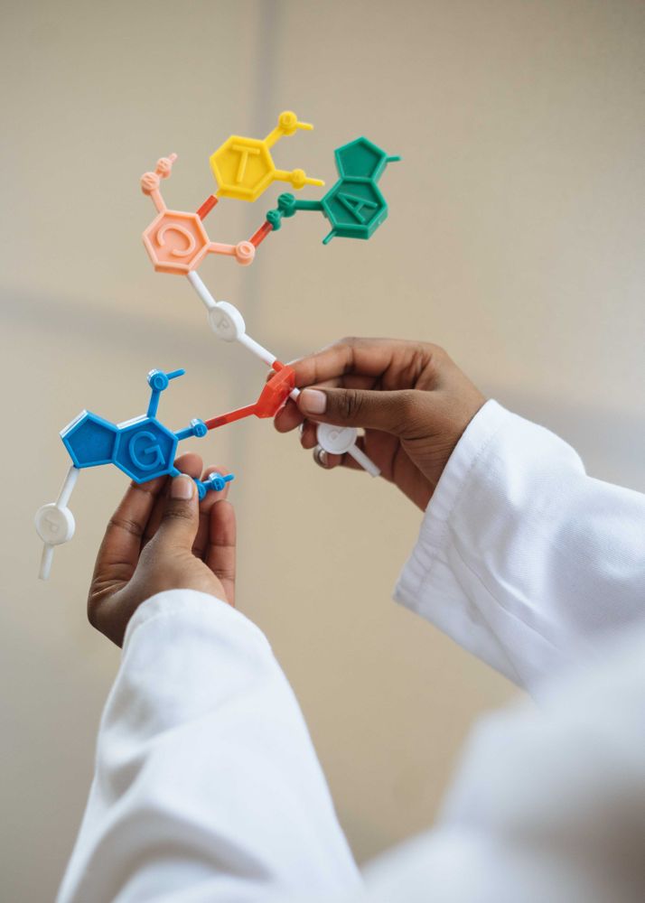 Cropped image of a person holding a physical model for chemical molecules