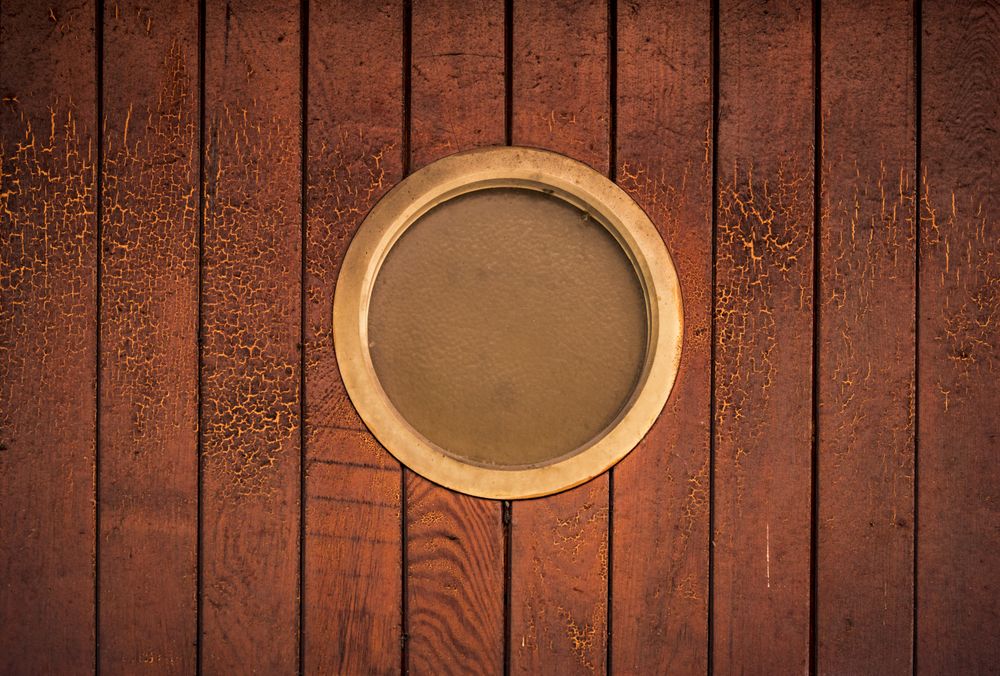 Round window on wooden wall