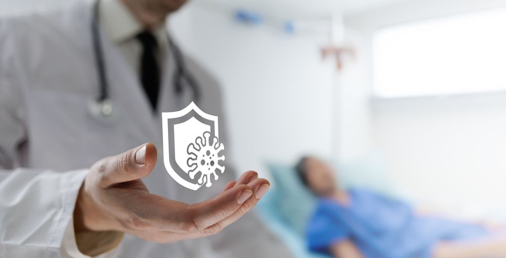 Doctor holds shield icon for protection
