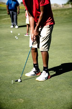 Cropped image of people at the golf court