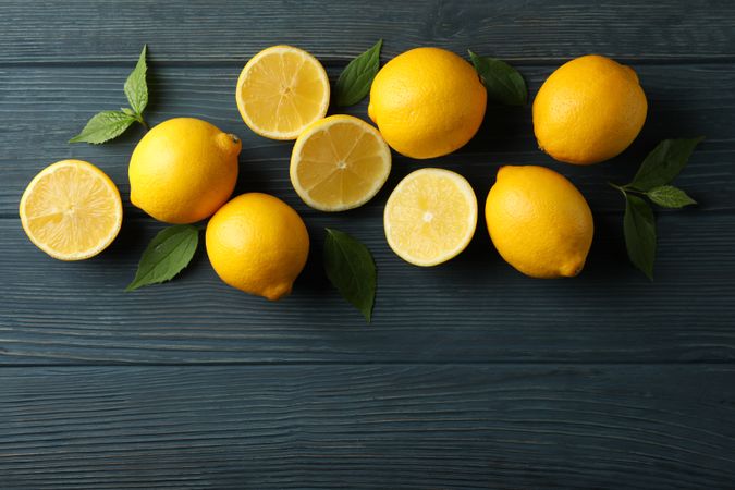 Fresh lemons on wooden background, top view. Ripe fruit