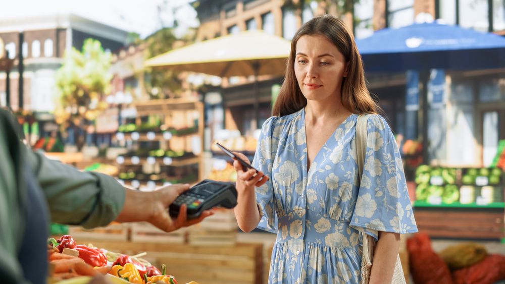 Street Vendor Holding an Electronic Online Payment Terminal Device
