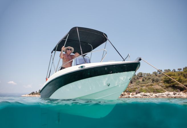 Man sailing in boat in clear turquoise water