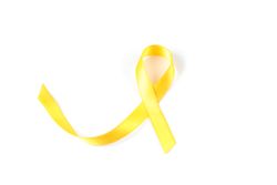 Yellow awareness ribbon isolated on blank background