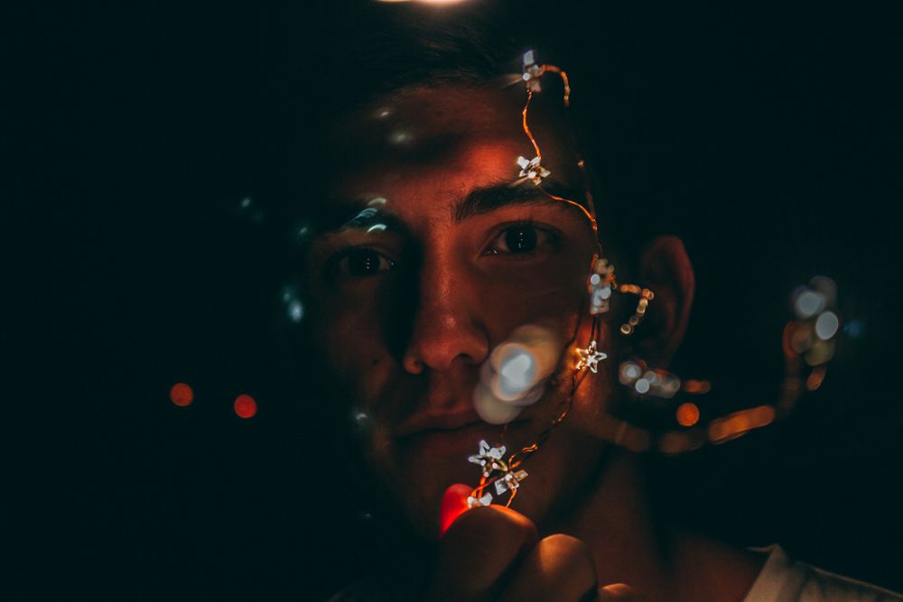 Portrait of man with string light