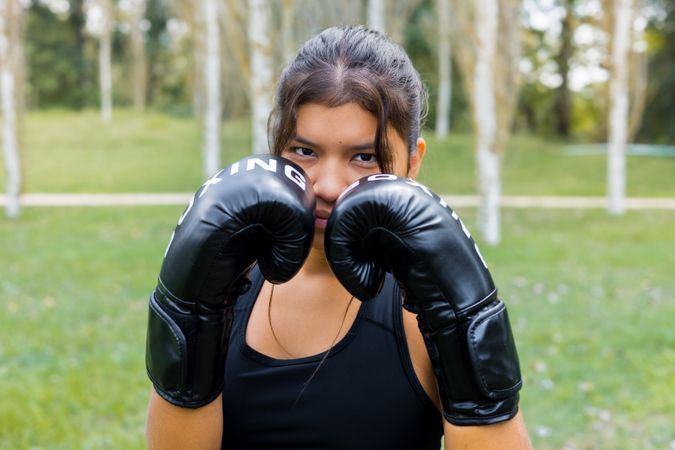 Boxer woman portrait wearing boxing gloves in a guard position