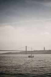 Modern boat in sea near coastal city