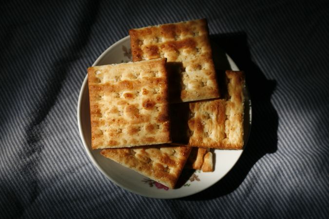 Top view of crackers on shadowy plate