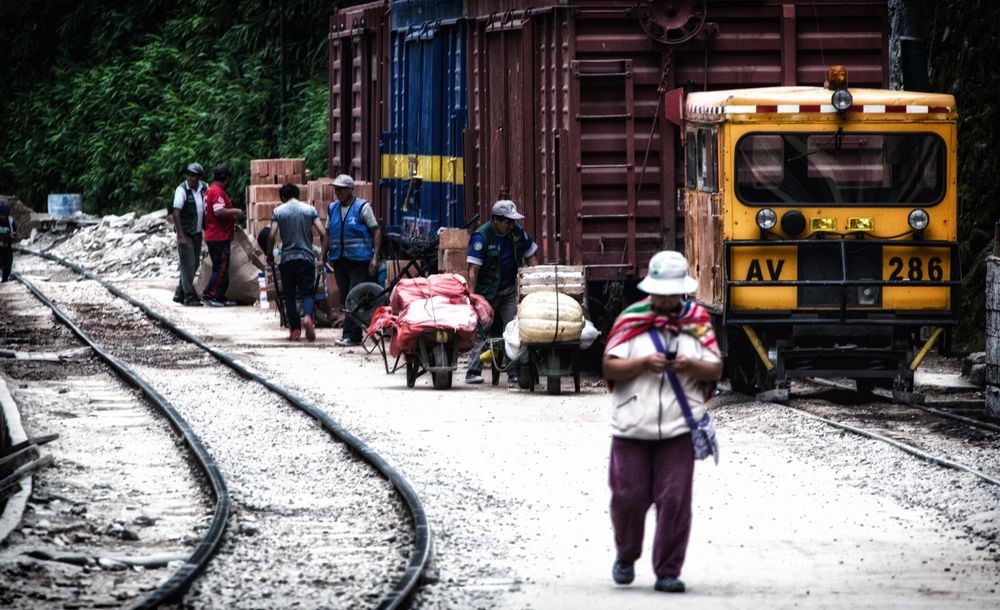 People standing near red train