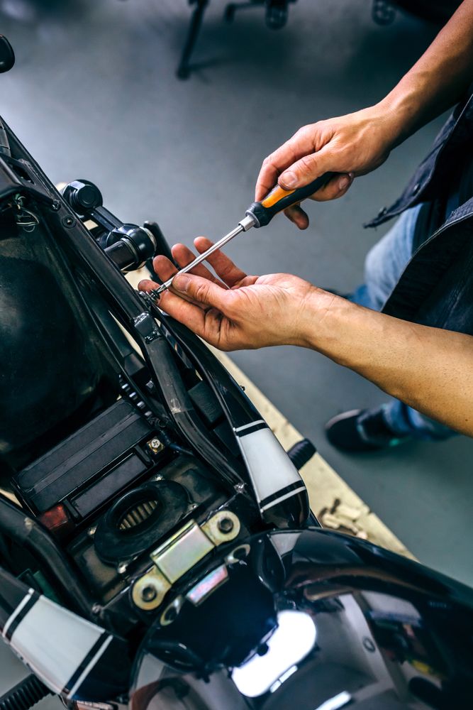 Mechanic repairing customized motorcycle