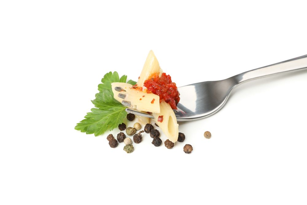 Fork with tasty pasta isolated on blank background