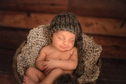 Naked baby sleeping in bucket