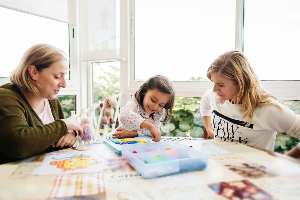 Woman playing board game with daughter and granddaughter