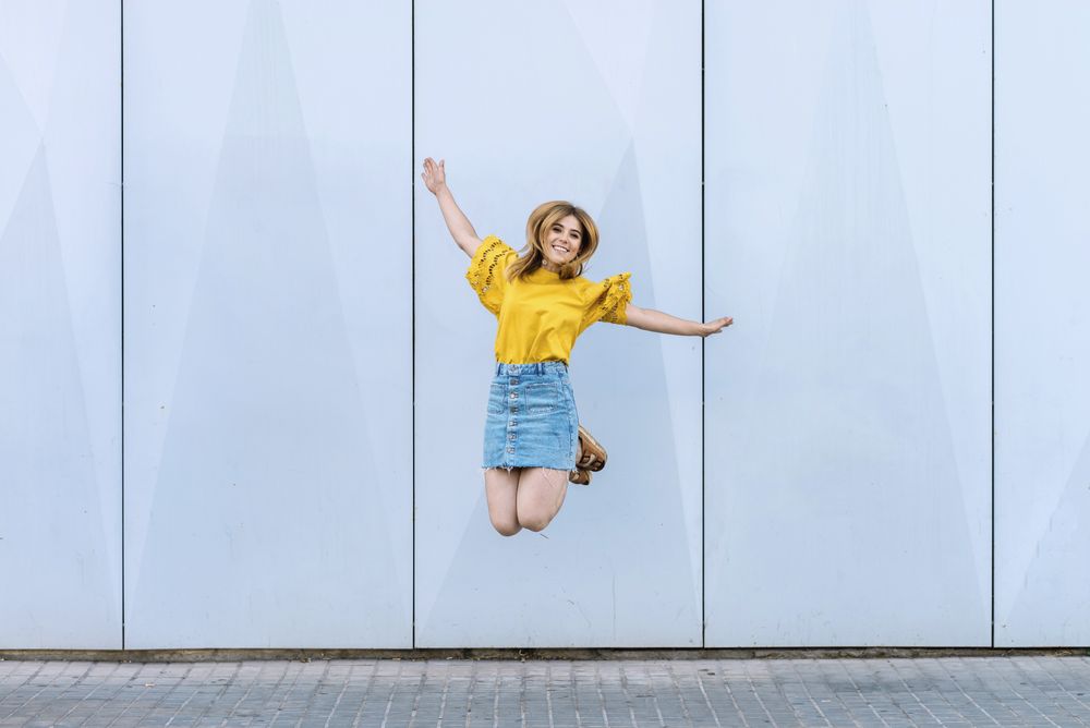 Young cheerful woman jumping