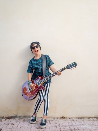 Energetic kid holding guitar