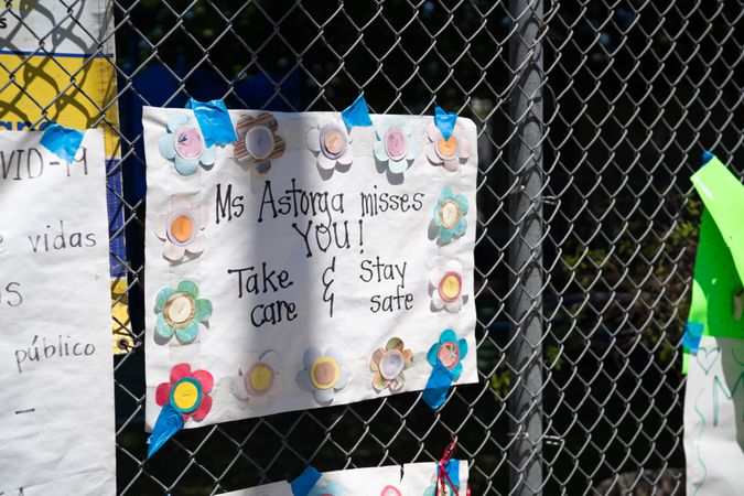 Homemade sign made by teacher telling her students that she misses them