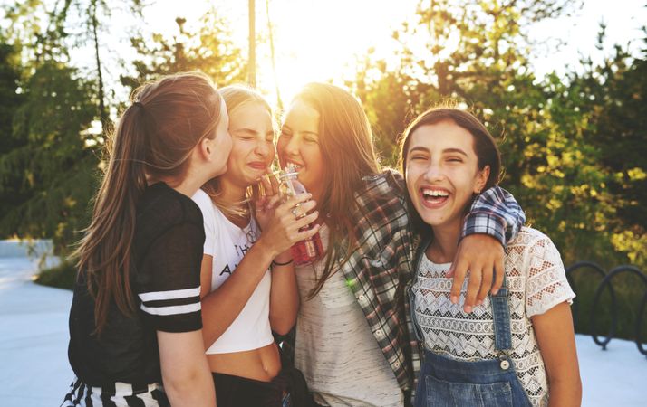Group of female teenagers laughing together in the sun