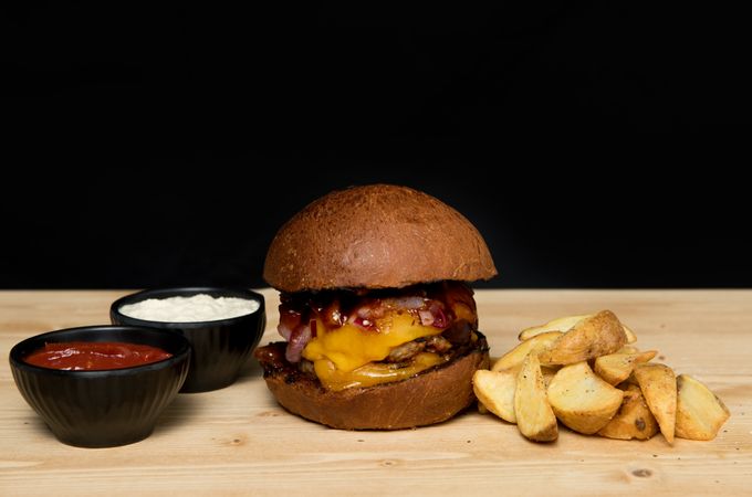 Sauces near burger and fried potato