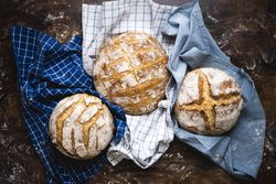 Whole loaves of sourdough on a baker counter
