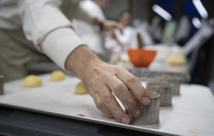 Men baking buns in kitchen