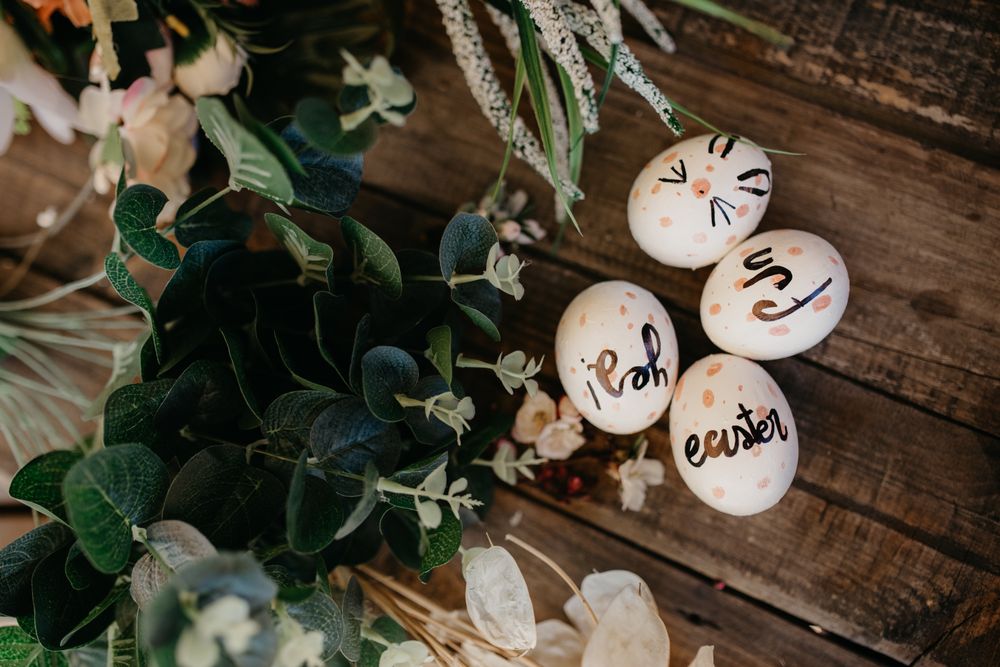 Easter eggs hand painted by children with messages in a wooden table