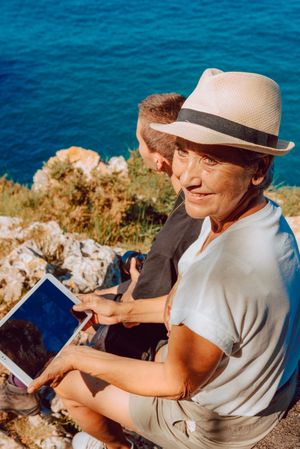 Stylish woman with tablet in hands and older woman