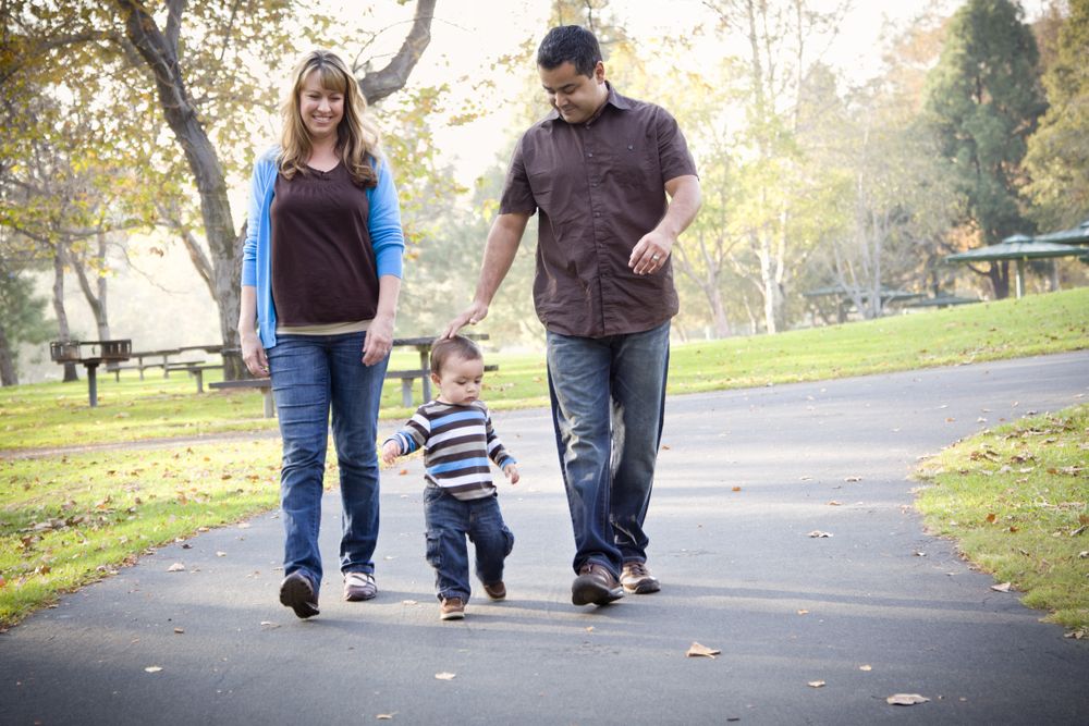 Happy Family Walking In The Park