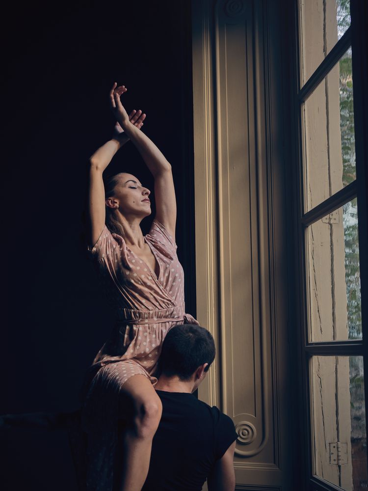 ballerina on shoulder of faceless dancer