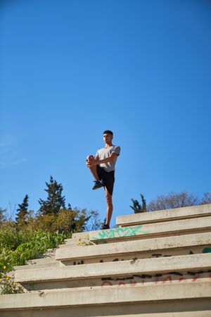 Man stretching legs on steps