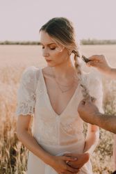 Woman in lace dress standing with fold hand