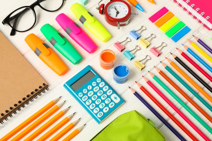 Flat lay composition with school supplies on wooden background