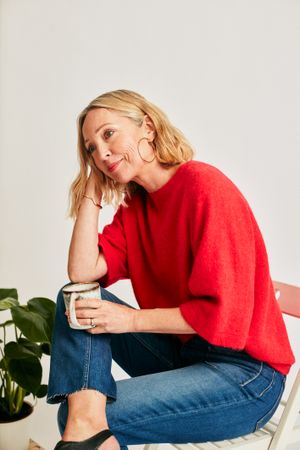 Woman sitting in chair leaning her head on her hands