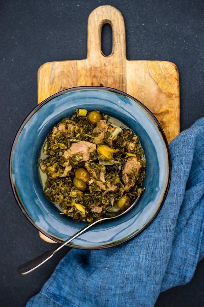 Chakapuli is a Georgian stew on blue plate