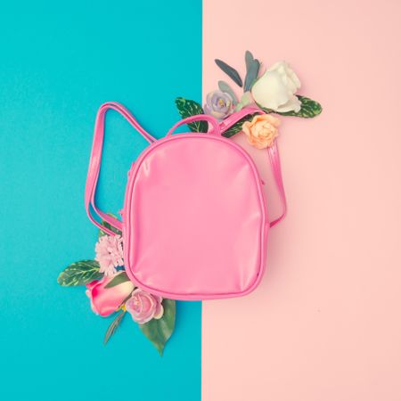 Pink school bag flowers on minimal pastel pink and blue background