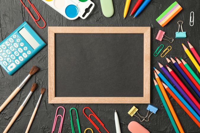 Composition with school supplies on dark background, space for text