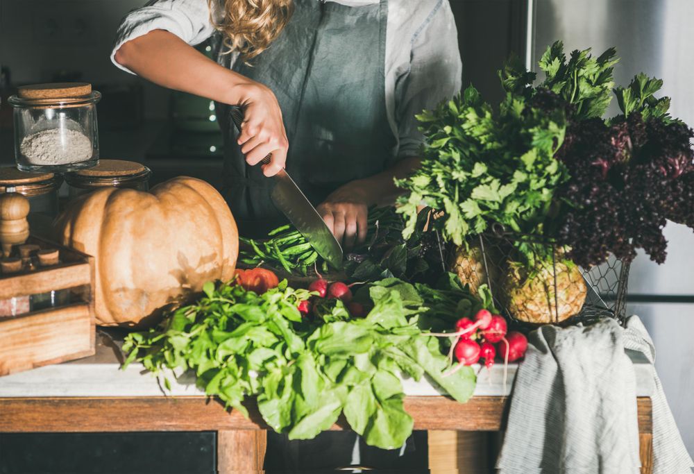 Woman cutting long beans in kitchen