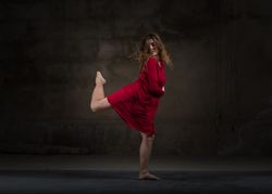 Young woman dancing in darkness