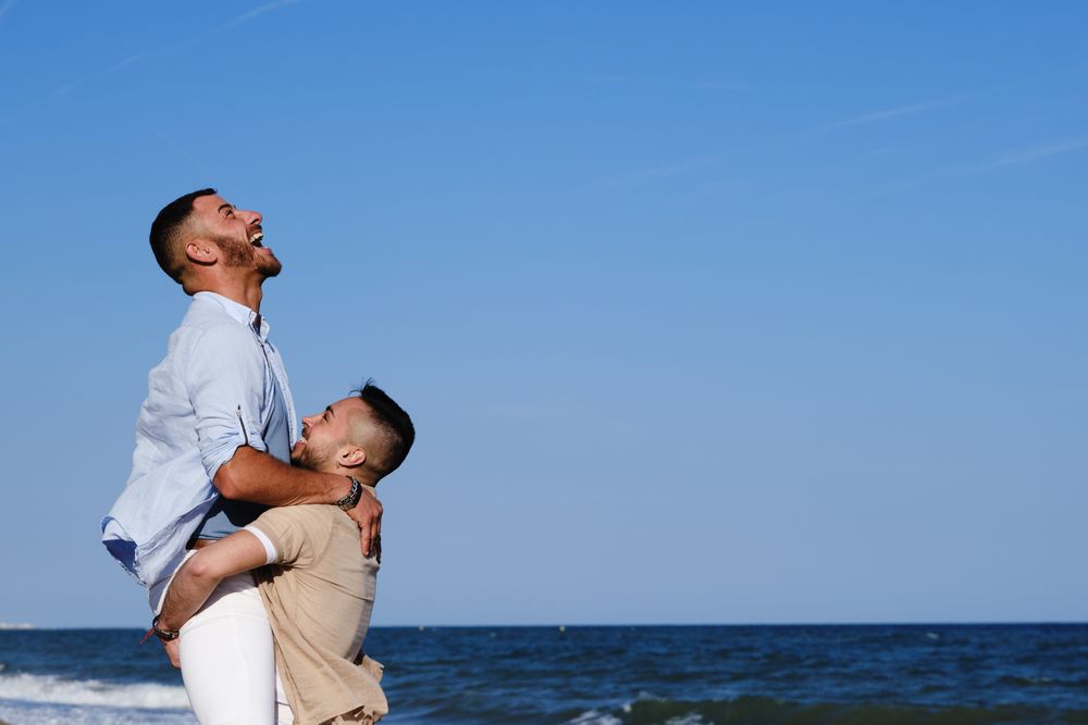 Happy gay couple enjoying and embracing outdoors