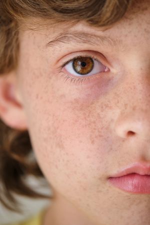 Crop boy with brown eye and freckles