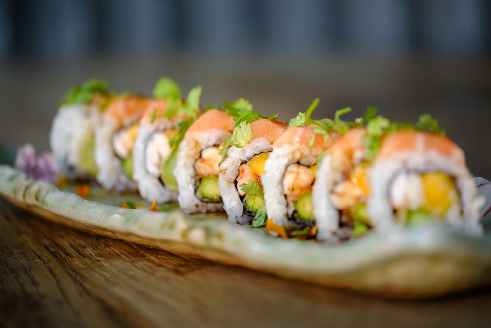 suramaki sushi with salmon and fresh vegetable with avocado on marble tray