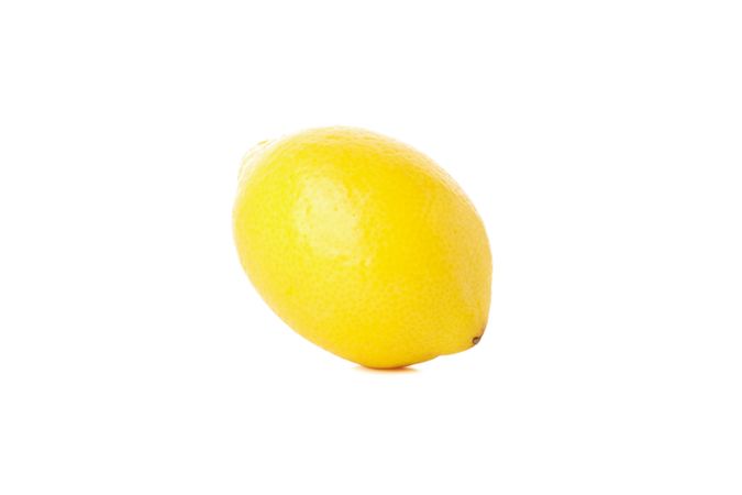 Fresh lemon isolated on light background. Ripe fruit