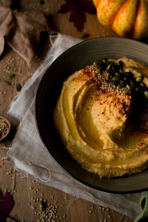 Dried leaves and napkins near pumpkin hummus