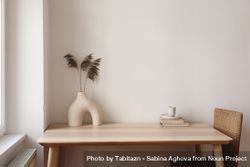 Table with modernist vase and decorative reeds 5ora80