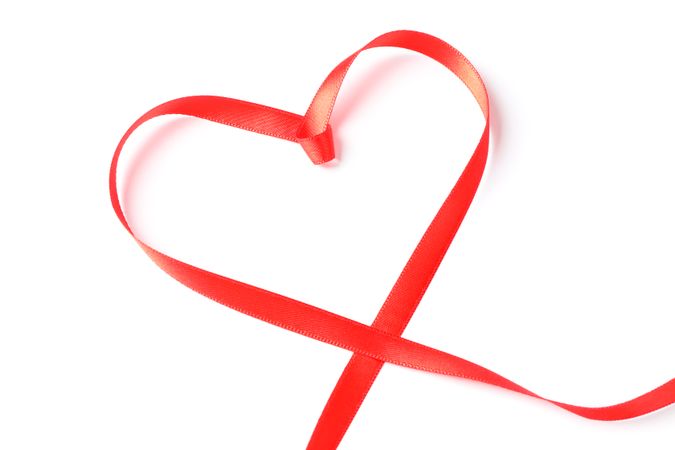 Red ribbon heart isolated on blank background