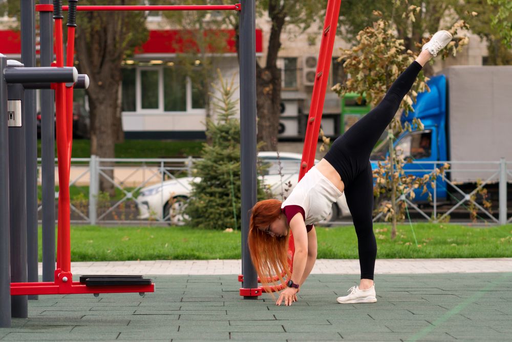 Woman performing leg lift stretch while bending forward