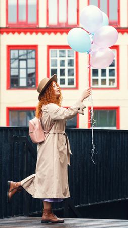 Woman in streets with balloons