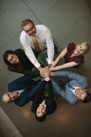 Business team hands stacked together