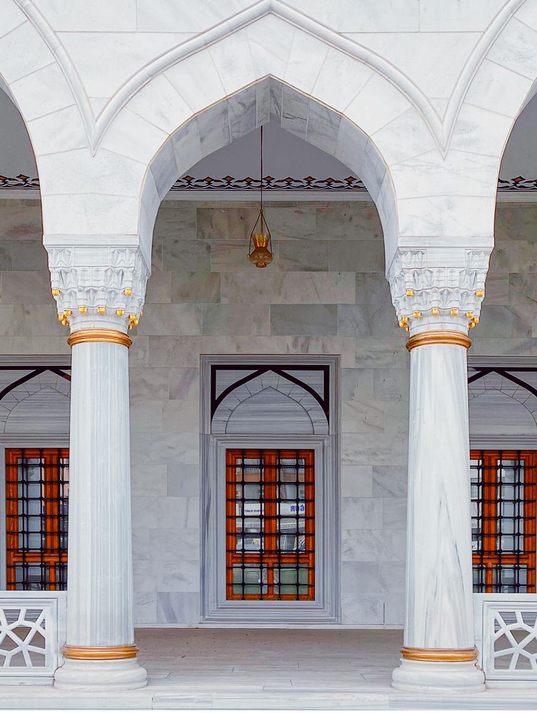 Arch over walkway in mosque with barred windows