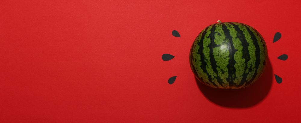 Ripe, juicy watermelon on a red background
